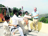 Ren Bo Kan Karate Do international instructor Peter Zaupa gives tips to students in Mussoorie on Monday. 