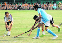 Players in action in the Dehradun District Council Schools Association Inter-school Girls' Hockey Tournament in Dehradun on Monday. 
