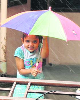 A girl having fun as sudden showers lash Karnal