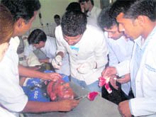 Doctors examine a person who was injured in a car bomb blast in Udhampur on Monday