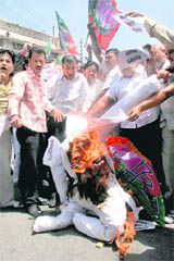 Activists of the BJYM burn an effigy of Revenue Minister Raman Bhalla in protest against the revocation of the Dogra certificate order in Jammu on Monday.