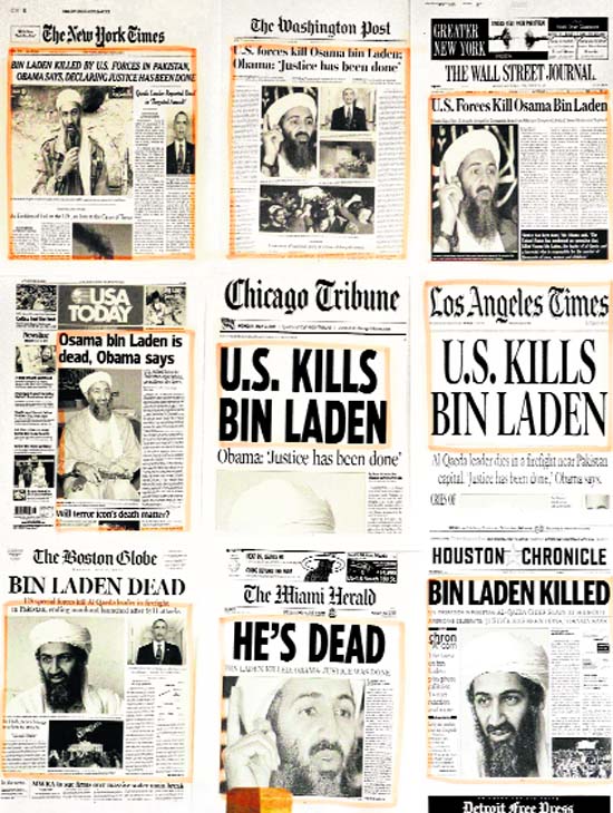Newspaper headlines and clippings are posted on a wall inside a staff office at the White House on Monday morning after US President Barack Obama announced the death of Osama bin Laden