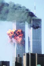 The World Trade Center south tower (left) bursts into flames after being struck by hijacked United Airlines Flight 175, as the north tower burns following an earlier attack, in New York City