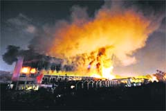 A cloud of smoke billows from the burning Marriott hotel following a bomb blast blamed on Al-Qaida, in Islamabad