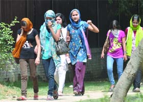 Girls cover their faces with dupattas to save themselves from the scorching heat in New Delhi on Tuesday