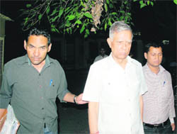 Former Energy Adviser to the Chief Minister and former Chairman of the Uttarakhand Jal Vidyut Nigam Yogendra Prasad is taken by vigilance officials to be produced in court in Dehradun 
