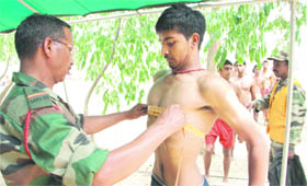 An Army personnel conducts the physical measurement test on a candidate at PAP Ground in Jalandhar on Tuesday.