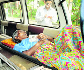 A patient being carried in an ambulance to cast the vote at a polling station during the fourth phase of West Bengal Assembly elections in Burdwan 