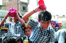 A school kid tries to cool off on his way back home in Bathinda on a hot Wednesday afternoon.