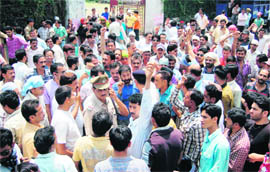 Contractual employees of the power corporations hold a demonstration in support of their demands in Dehradun on Wednesday.
