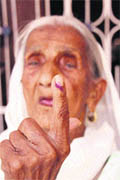 Shamo Devi, 98, shows the ink impression on her finger after casting her vote at Kakrai village in the Mazalta block on Wednesday.