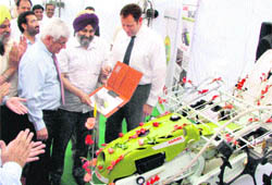 Navreet Singh Kang, acting Vice-Chancellor of the PAU, is handed over a paddy transplanter in Ludhiana