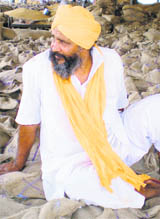 A farmer waits for buyers.