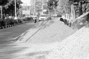 Concrete spread on a road is a hinderance commuters in Phase-5 and Industrial Area, Phase-2, in Mohali.