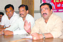 Gaurav Kumar (right), president of the state unit of the Shiv Sena, addresses a press conference in Dehradun on Thursday.