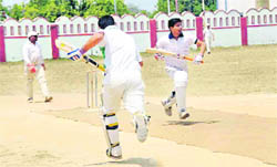 Bastmen cross over for a run in a match in the Central Government Employees Welfare Committee Cricket Tournament in Dehradun on Thursday. 