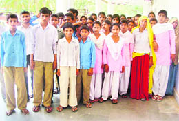 Schoolchildren and elders demand removal of a liquor vend in Bishanpur village of Rewari.