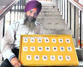 Narinder Pal Singh with his collection of coins
