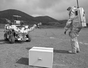 A person wearing a Mars suit Aouda.X prototype walks towards Mars rover Eurobot of the European Space Agency (ESA) during testing in the semi-desert of Rio Tinto, Spain, on April 20, 2011.