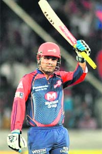 Delhi Daredevils captain Virender Sehwag raises his bat after completing his ton in Hydera-bad on Thursday