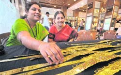 Akshaya Tritiya: A woman checks a gold waist belt at a jewellery shop in Hyderabad
