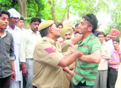 A policeman tries to arrest one of the undertrials, who escaped when they were produced in a court