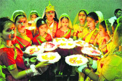 Girls await their turn to perform on stage during the inaugural function of the Maharaja Hari Singh Memorial National Karate Championship at the MA Stadium in Jammu on Friday