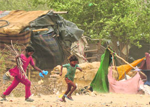 Children run for cover as a sandstorm hits Ludhiana on Friday.