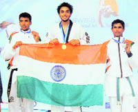 Ramandeep Singh (second from left), a student of DAV Model Senior Secondary School, Sector 15, Chandigarh, with the Tricolour after winning the gold medal in Pune.