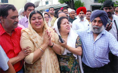 Grief-stricken sisters of Tejpal Singh Mamik (top inset) are consoled by family members in Dehradun on Saturday. 