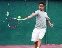 A player returns a shot in the Uttarakhand State Open Junior Tennis Tournament in Dehradun on Saturday. 