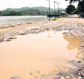 A road along the Surinsar lake in a dilapidated contition.