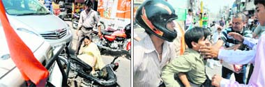 A woman falls after being hit by an MUV at the Bhai Bala Chowk on the Pakhowal Road; and (right) a traffic marshal (in T-shirt) slaps a traffic violator while students of Shifaly International School were learning lessons in traffic management on Saturday