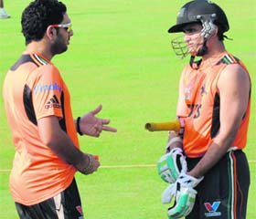 Pune Warriors captain Yuvraj Singh (L) chats with Sourav Ganguly at the Sector 16 stadium in Chandigarh on Saturday