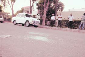 Shreds of glass lie scattered at the scene where two shots were fired, in Phase 3B1, Mohali, on Sunday