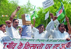 Activists of the Janata Dal (U) Kisan Sabha protest against UP Chief Minister Mayawati over the clash between farmers and police in Greater Noida, at Jantar Mantar in New Delhi on Sunday