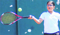 A player in action at the 12th Uttarakhand State Open Junior Tennis Tournament in Dehradun on Sunday