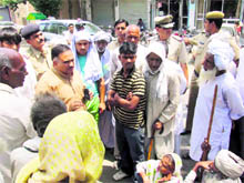 BJPs state media in charge Rajiv Jain interacts with senior citizens during a road blockade in Sonepat on Sunday