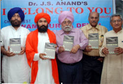 Swami Suriya Dev releasing Dr JS Anand's book I Belong To You during a function in Bathinda on Sunday.