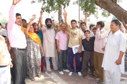 Residents of Gopal Nagar protest against the opening of a liquor shop in their locality in Bathinda on Monday.
