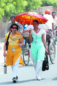 Protective gears are out as the mercury soars, in Bathinda on Monday.