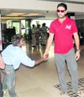 Dharamvir Singh congratulates Yuvraj Singh after the victory of the latters team.