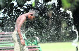 Gushing water from a hose gives relief to this boy in sweltering heat in Mohali