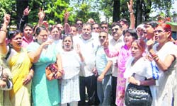 Congress workers stage a protest at the office of the District Magistrate in Dehradun