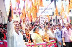 Shiv Sena wokers hold a demonstration outside the office of the District Magistrate, Dehradun