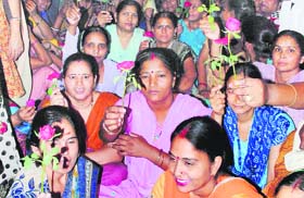 Resorting to Gandhigiri: Women protest outside the office of the Deputy Commissioner in Faridabad on Monday