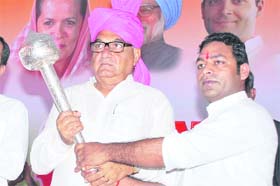 MLA Anil Dhantori honours Chief Minister Bhupinder Singh Hooda with a mace at Shahbad in Kurukshetra on Monday