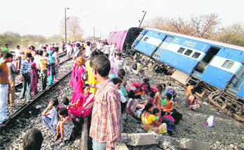 Passengers of the Mumbai-Pratapgarh Udyognagri Express wait to be evacuated after some coaches of the train derailed near Vidisha in Madhya Pradesh