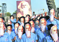 Students wearing the masks of Gurudev Rabindranath Tagore during a function to commemorate the 150th birth anniversary of Tagore in Malda district of West Bengal