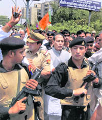 BJP leader Rajnath Singh is escorted after his arrest by the police while he was on the way to meet agitating farmers of Bhatta Parsaul village, in Noida